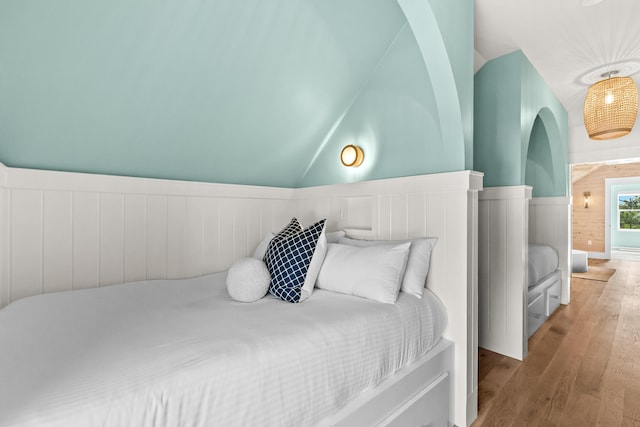 bedroom featuring lofted ceiling and hardwood / wood-style flooring