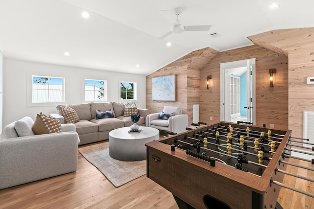 playroom featuring wood-type flooring, wood walls, ceiling fan, and vaulted ceiling