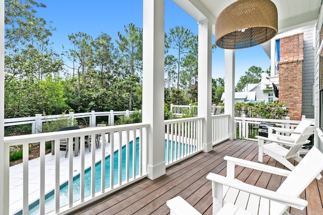 wooden deck featuring a fenced in pool