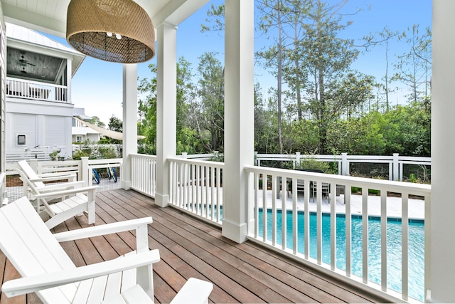 deck featuring a fenced in pool