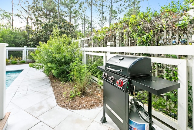 view of patio / terrace with a grill and a fenced in pool