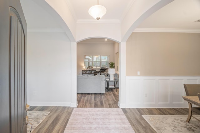 entryway with crown molding and hardwood / wood-style floors