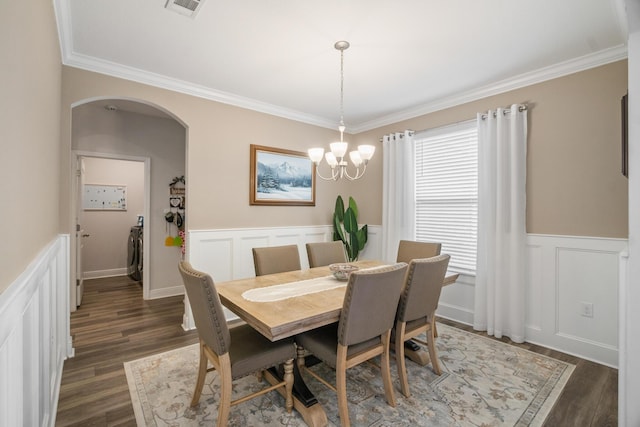 dining area with ornamental molding, dark hardwood / wood-style flooring, and plenty of natural light