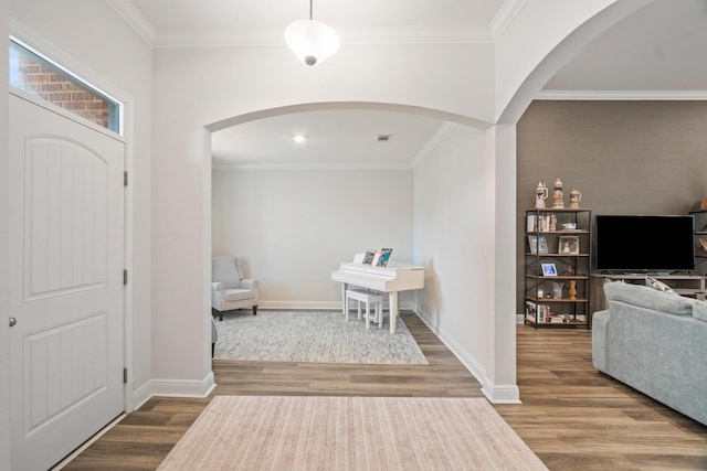 entrance foyer with hardwood / wood-style floors and crown molding