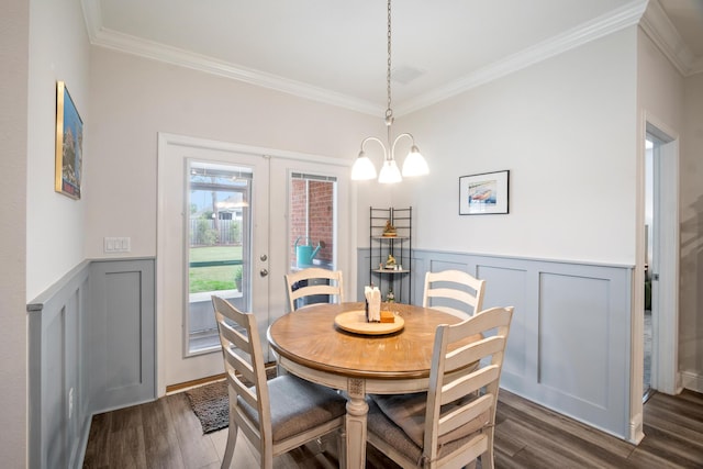 dining space with an inviting chandelier, french doors, dark hardwood / wood-style flooring, and crown molding