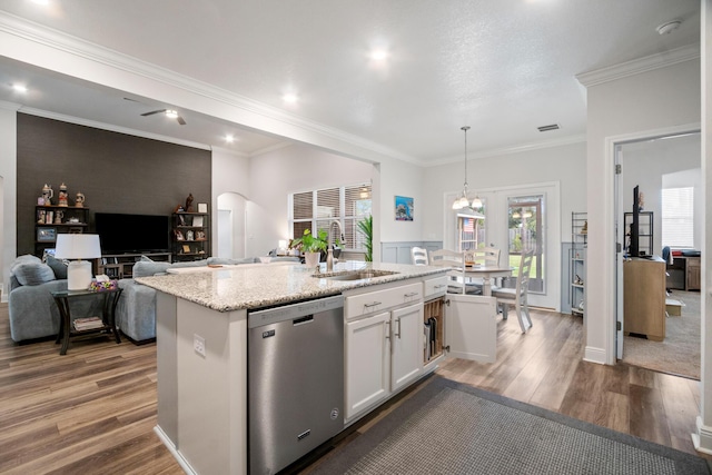 kitchen with decorative light fixtures, white cabinetry, sink, a kitchen island with sink, and stainless steel dishwasher