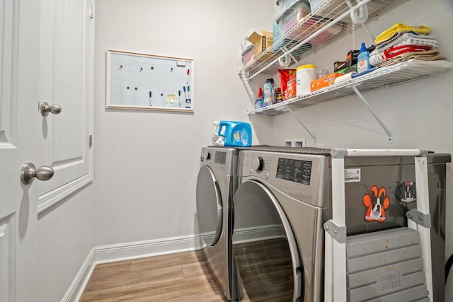 laundry area featuring washer and clothes dryer and wood-type flooring