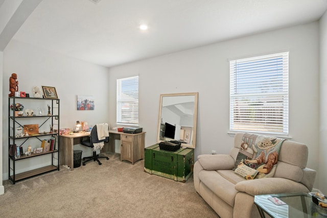 office area with plenty of natural light and light carpet