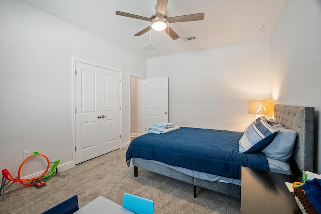 bedroom with ceiling fan, a closet, and carpet flooring