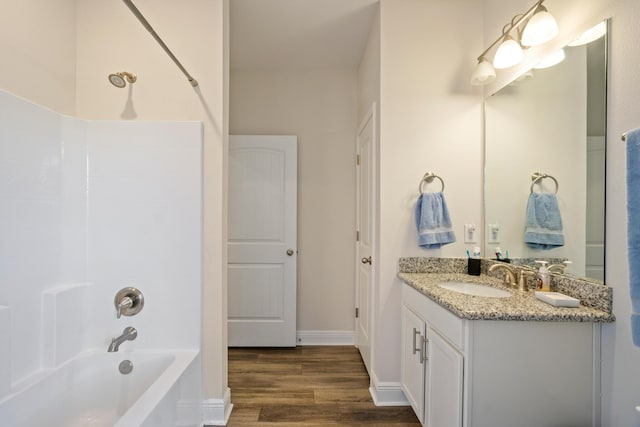 bathroom featuring shower / bathing tub combination, vanity, and hardwood / wood-style floors