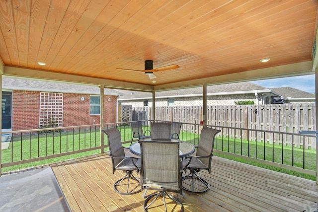 deck with ceiling fan and a yard