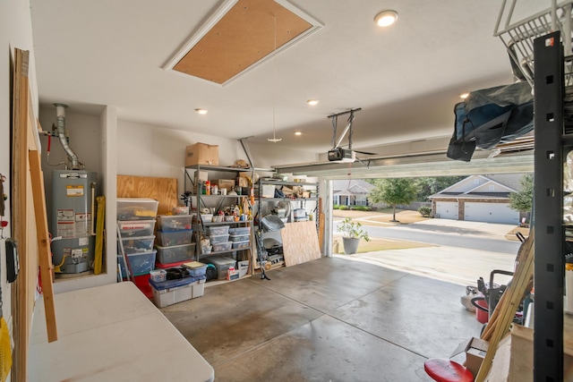 garage featuring water heater and a garage door opener