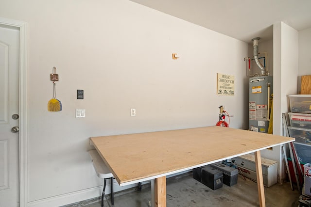 dining room featuring water heater and concrete flooring