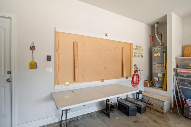 miscellaneous room featuring water heater and concrete floors