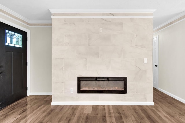 details with wood-type flooring, a tiled fireplace, and crown molding