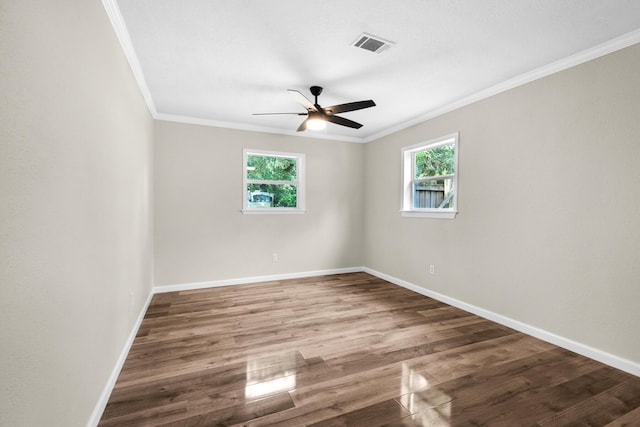 empty room featuring ceiling fan, ornamental molding, and dark hardwood / wood-style floors