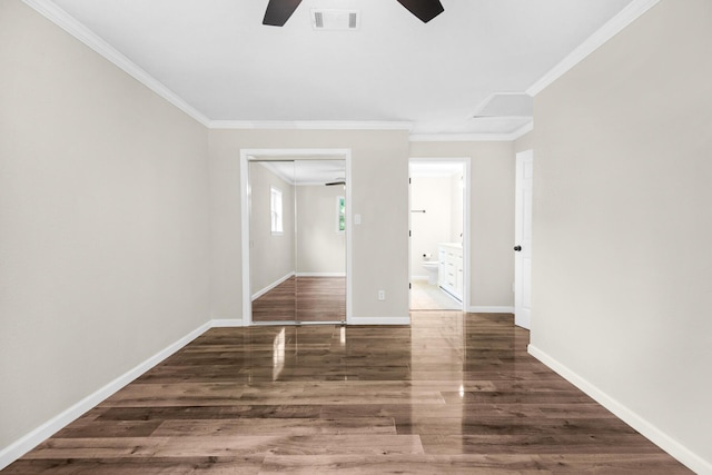 spare room with dark hardwood / wood-style flooring, ceiling fan, and crown molding