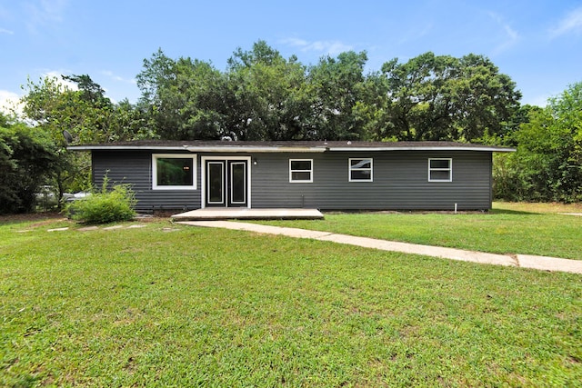 back of house featuring a patio area and a lawn