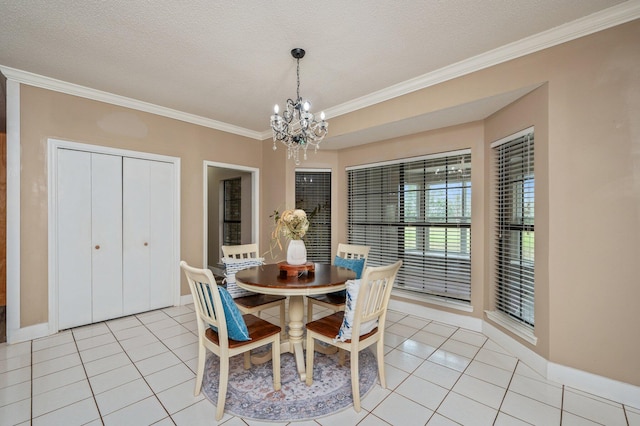 dining space featuring an inviting chandelier, light tile patterned floors, a textured ceiling, and ornamental molding