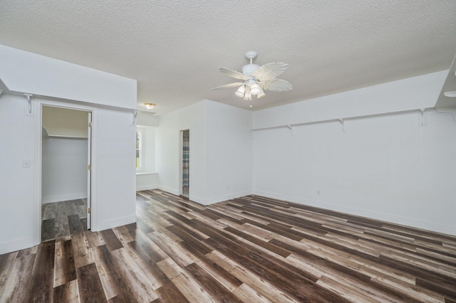 unfurnished bedroom featuring ceiling fan, a closet, dark wood-type flooring, and a textured ceiling