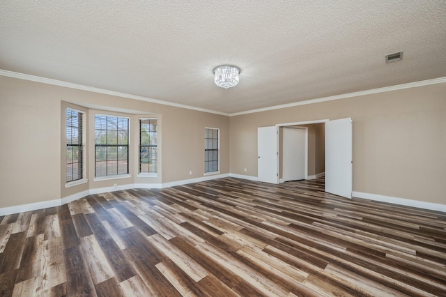 interior space with a textured ceiling, ornamental molding, and dark hardwood / wood-style flooring