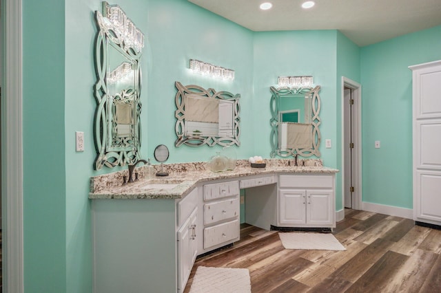 bathroom with vanity and wood-type flooring