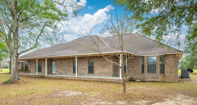 rear view of house featuring central AC, a patio, and a lawn