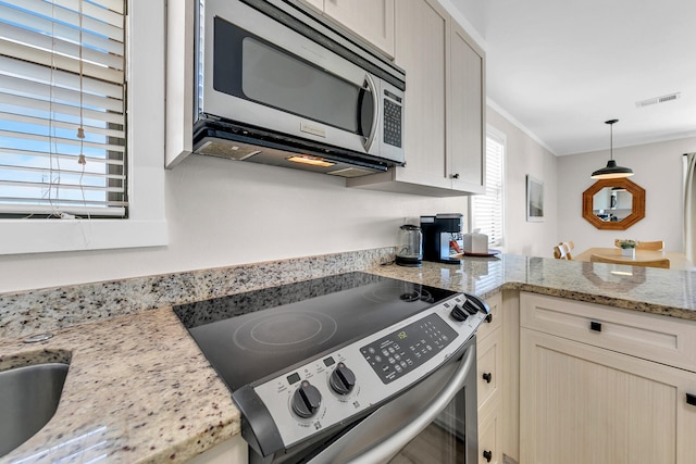 kitchen with stainless steel appliances, crown molding, light stone counters, and decorative light fixtures