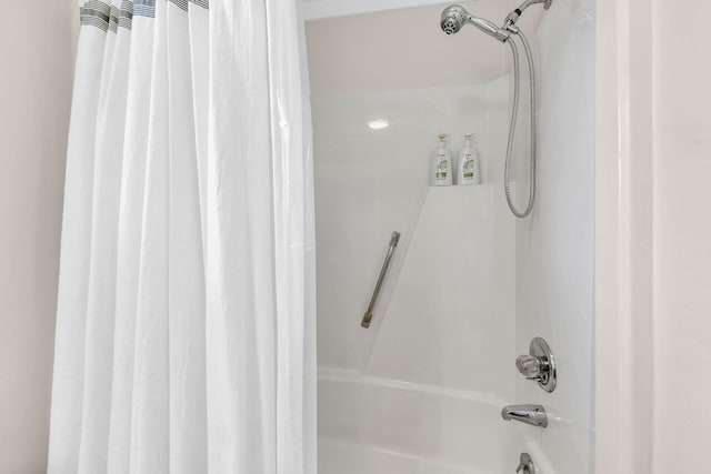 bathroom with shower / bathtub combination with curtain