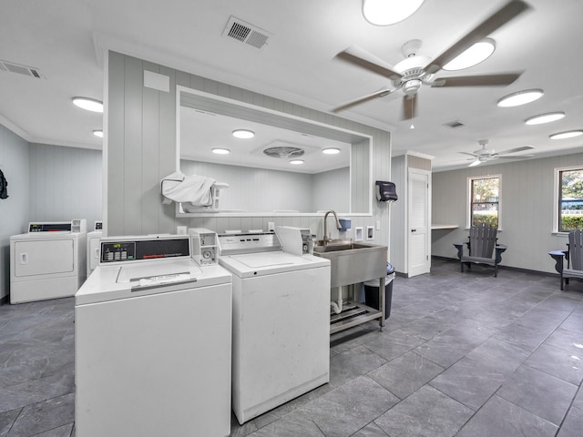 laundry area with ceiling fan, washing machine and clothes dryer, and ornamental molding