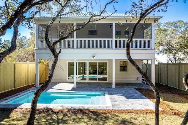 back of house featuring ceiling fan, a patio area, a balcony, and a sunroom