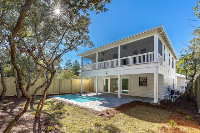 rear view of property with a fenced in pool, a patio, a balcony, and ceiling fan