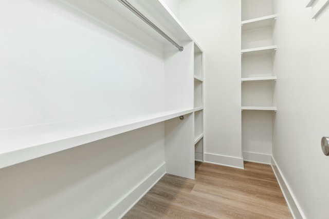 walk in closet featuring hardwood / wood-style floors