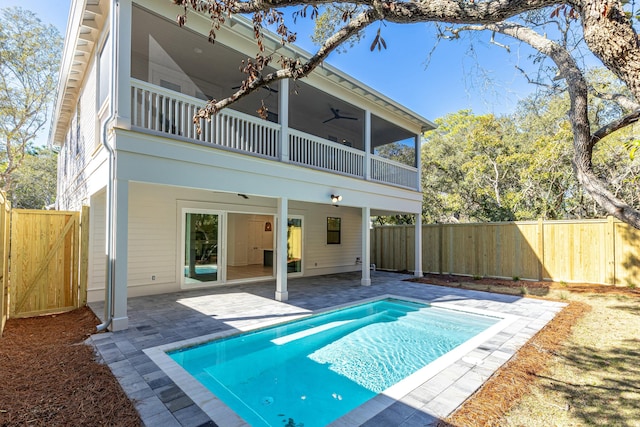 back of house featuring a sunroom, a balcony, a patio, and ceiling fan