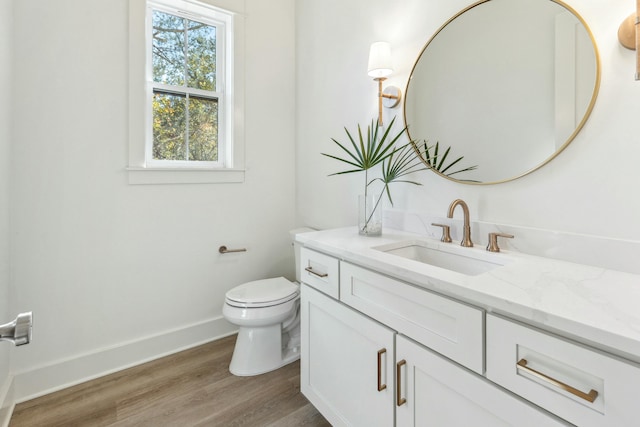 bathroom featuring hardwood / wood-style flooring, vanity, and toilet