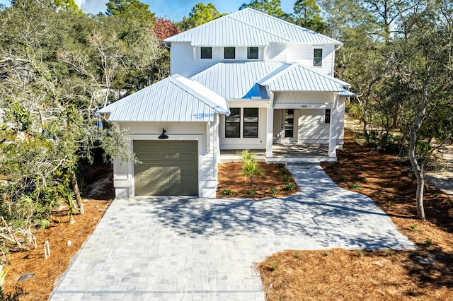 modern farmhouse style home with a garage and covered porch