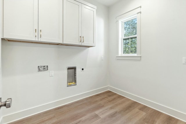 clothes washing area featuring washer hookup, light hardwood / wood-style flooring, cabinets, and hookup for an electric dryer