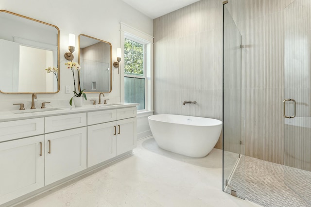 bathroom featuring vanity and independent shower and bath