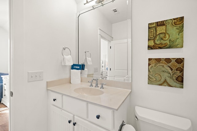 bathroom featuring toilet and vanity