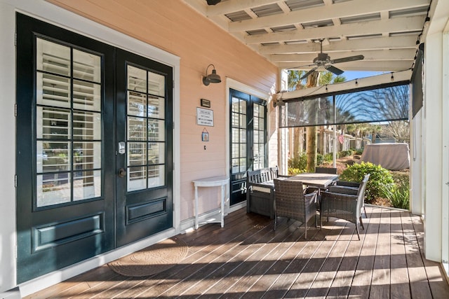 sunroom / solarium featuring ceiling fan, vaulted ceiling with beams, and a healthy amount of sunlight