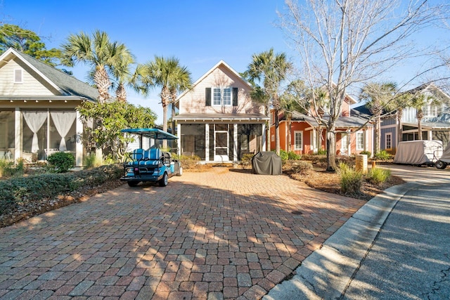 view of front of home featuring a sunroom