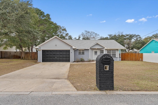 view of front of property with a front yard and a garage