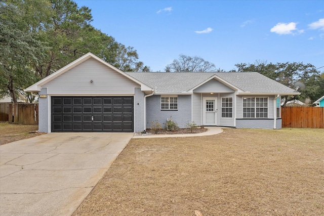 ranch-style house featuring a front lawn and a garage