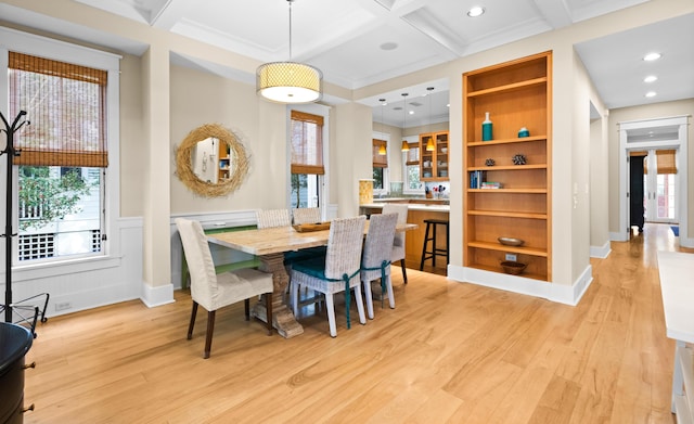 dining area with light hardwood / wood-style flooring, beamed ceiling, and coffered ceiling