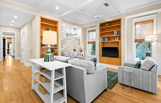 living room featuring hardwood / wood-style floors, plenty of natural light, coffered ceiling, and beamed ceiling