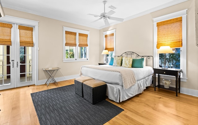 bedroom with hardwood / wood-style flooring, ceiling fan, access to exterior, french doors, and crown molding