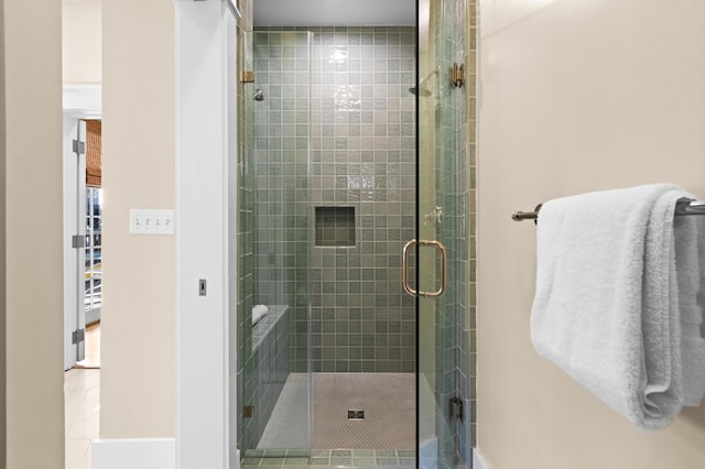 bathroom featuring a shower with shower door