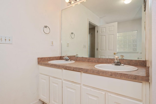 bathroom featuring double vanity and a sink