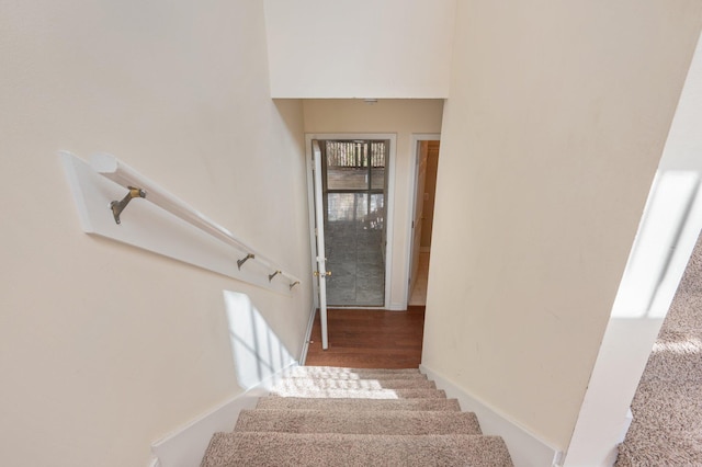 stairway featuring baseboards