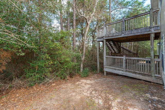 view of yard with stairway and a wooden deck